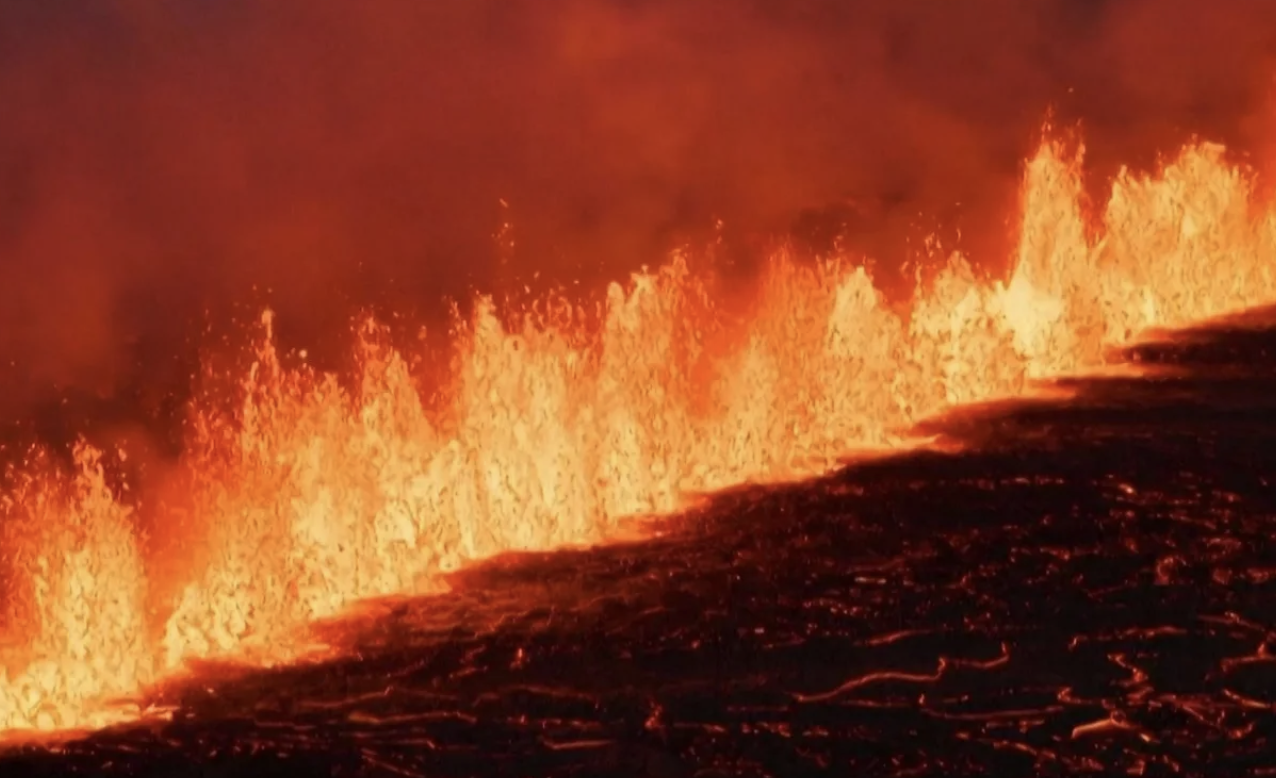 Iceland volcano erupts again spewing out streams of yellow and orange lava.